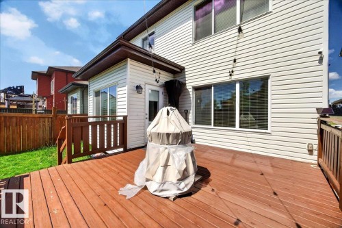 Expansive wood deck with a privacy fence and manicured lawn - 1411 30 Avenue, Edmonton, AB 