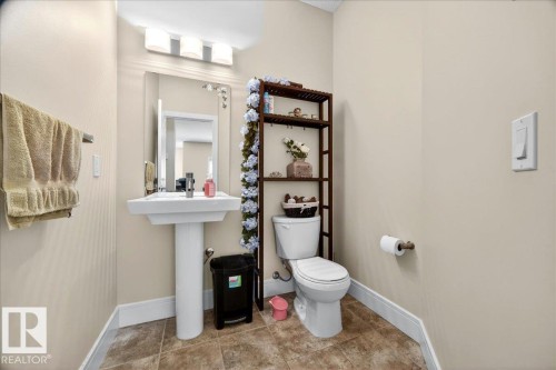 Pedestal sink with mirror and vanity lighting - 1411 30 Avenue, Edmonton, AB 