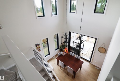 Two-story ceiling with multiple windows flooding the home with natural light. - 100 Graybriar Drive, Stony Plain, AB - Indoor Photo Showing Other Room