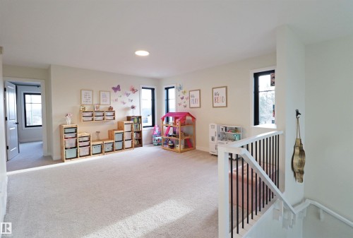 Open concept bonus room with neutral carpeting, recessed lighting, and multiple windows overlooking the golf course - 100 Graybriar Drive, Stony Plain, AB - Indoor Photo Showing Other Room