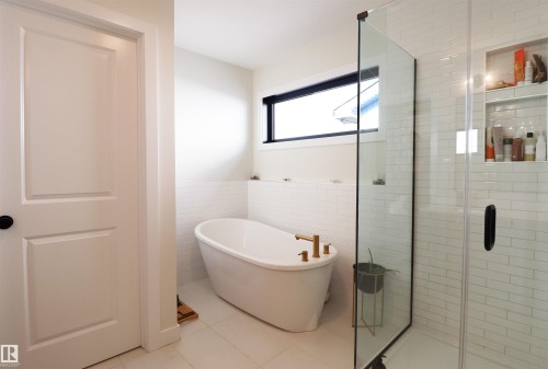Freestanding tub next to window. - 100 Graybriar Drive, Stony Plain, AB - Indoor Photo Showing Bathroom