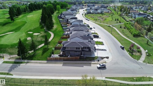 Aerial perspective showcasing a residential street bordered by the municipal golf course and green space across from residence - 100 Graybriar Drive, Stony Plain, AB - Outdoor With View