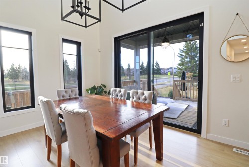 Dining area featuring a sliding glass patio door, leading to the south facing covered deck. - 100 Graybriar Drive, Stony Plain, AB - Indoor Photo Showing Dining Room