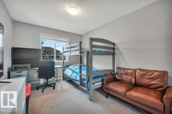 Bright room with neutral gray walls, a window offering exterior exposure, light-colored carpet flooring, and a flush-mount ceiling light fixture - 