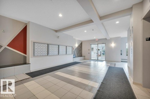 Lobby featuring ceramic tile flooring and recessed lighting - 219 1820 Rutherford Road, Edmonton, AB 