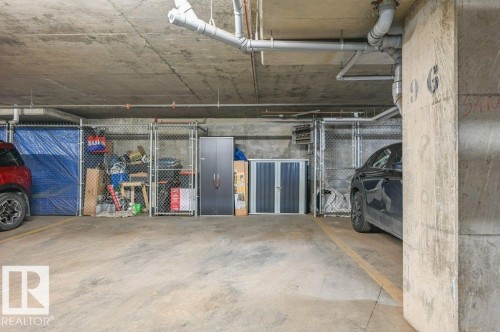 Paved parking area with overhead piping, concrete ceiling, and support columns - 219 1820 Rutherford Road, Edmonton, AB 