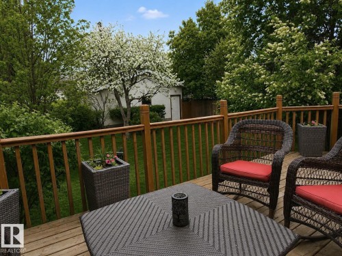 Expansive wood-finish deck with a wood railing system - 9813 152 Street, Edmonton, AB 