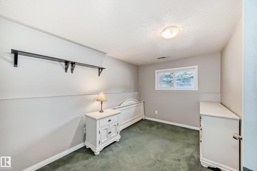 Room with light-colored walls and green carpeting - 9813 152 Street, Edmonton, AB 