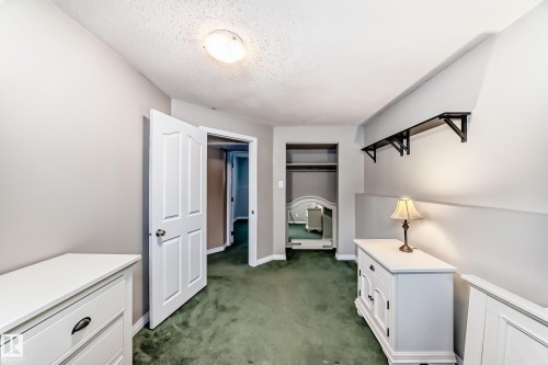 Interior space featuring green carpeting and light gray walls - 9813 152 Street, Edmonton, AB 