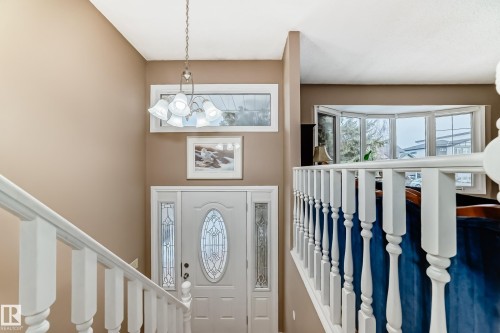 Foyer with a white entry door featuring decorative glass inserts and sidelights - 9813 152 Street, Edmonton, AB 