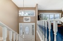 Foyer with a white entry door featuring decorative glass inserts and sidelights - 9813 152 Street, Edmonton, AB 