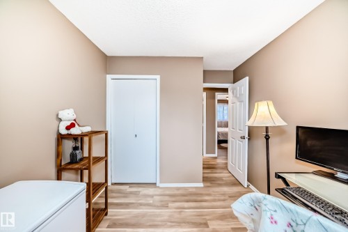 Interior room featuring wood-finish flooring, neutral wall tones, and white trim - 9813 152 Street, Edmonton, AB 