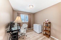 Room featuring wood-finish flooring, a double-paned window with curtain rods, neutral wall paint, and a ceiling-mounted light fixture - 
