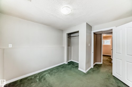 Room featuring green carpeting and neutral wall tones - 9813 152 Street, Edmonton, AB 