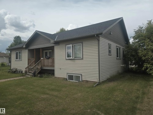 Single-story residence featuring light-colored horizontal siding and a dark shingled roof - 4808 50 Avenue, Lamont, AB 