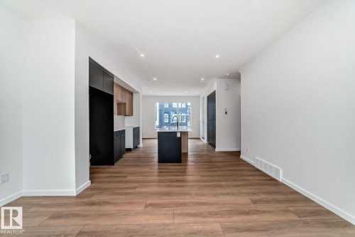Expansive living area featuring wide plank wood-finish flooring - #66 5 Rondeau Dr, St. Albert, AB - Indoor Photo Showing Other Room
