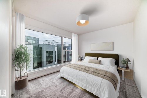 Expansive window with a contemporary urban backdrop, plush patterned carpeting, built-in ceiling light fixture, and floor-to-ceiling white window treatments - #66 5 Rondeau Dr, St. Albert, AB - Indoor Photo Showing Bedroom