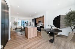 Open-concept living space with wood-finish flooring throughout - 