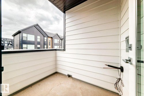 Private balcony featuring horizontal white siding and a concrete floor - #66 5 Rondeau Dr, St. Albert, AB - Outdoor With Exterior