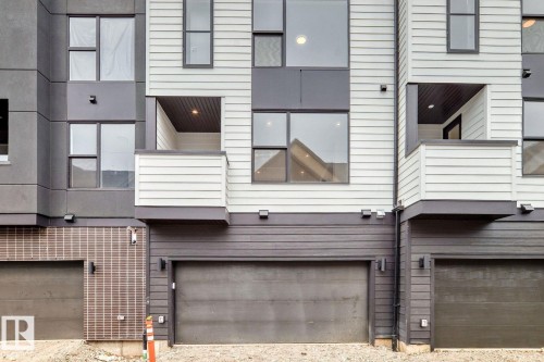 Contemporary townhome facade featuring multi-tone horizontal siding and dark trim - #66 5 Rondeau Dr, St. Albert, AB - Outdoor With Exterior