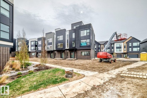 Contemporary multi-level residences featuring varied dark-toned siding, large window compositions, and private entries - #66 5 Rondeau Dr, St. Albert, AB - Outdoor