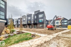 Contemporary multi-level residences featuring varied dark-toned siding, large window compositions, and private entries - 