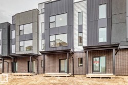 Modern townhome exteriors featuring multi-textured facades, large windows, covered patios, sliding glass doors, and durable brick-finish lower levels - 
