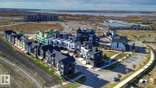 Contemporary row homes and townhomes featuring a variety of exterior finishes, including dark siding and lighter panels - #66 5 Rondeau Dr, St. Albert, AB - Outdoor With View