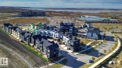 Contemporary row homes and townhomes featuring a variety of exterior finishes, including dark siding and lighter panels - 