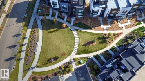 Central green space featuring manicured lawns and mature plantings - #66 5 Rondeau Dr, St. Albert, AB - Outdoor With View