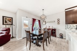 Dining area featuring light wood-finish flooring and a contemporary geometric chandelier - 