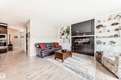 Living area featuring light wood-finish flooring and recessed lighting - 