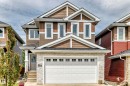 Two-story residence featuring a prominent front-facing garage with frosted window inserts - 3895 Robins Crescent, Edmonton, AB 