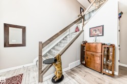 Staircase featuring glass panel railings and wood-finish treads - 