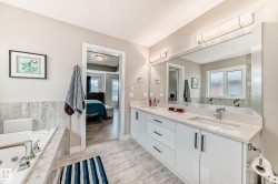 Dual vanity with white cabinetry, integrated sinks, and polished chrome fixtures - 