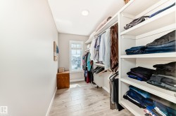 Custom closet system featuring extensive shelving and hanging rods - 