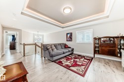 Tray ceiling with recessed lighting and a central flush-mount fixture - 