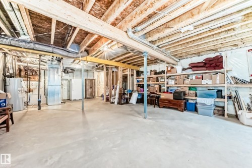 Unfinished basement featuring exposed wood joists and concrete flooring - 3895 Robins Crescent, Edmonton, AB 