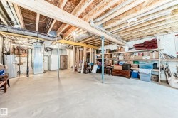 Unfinished basement featuring exposed wood joists and concrete flooring - 