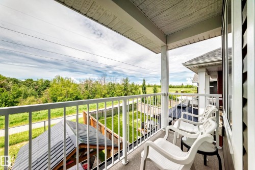 Upper-level balcony featuring white railings, a covered ceiling, and exterior siding - 3895 Robins Crescent, Edmonton, AB 