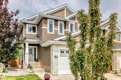Two-story residence featuring composite siding and stone accents - 