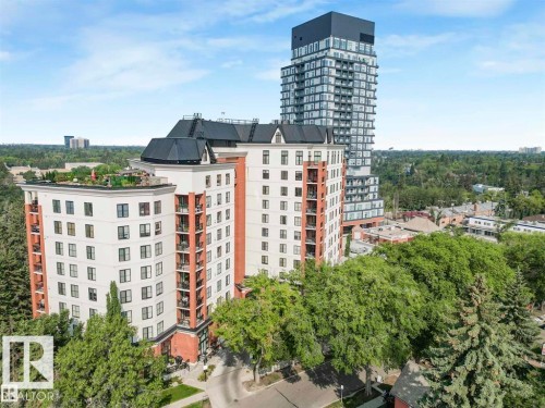 Multi-story residential buildings featuring brick and light-toned facades, black framed windows, and individual balconies - 902 10108 125 Street, Edmonton, AB 