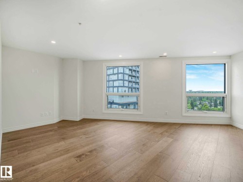 Bright interior space featuring light wood-finish flooring, recessed lighting, and white baseboards - 902 10108 125 Street, Edmonton, AB 