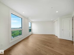Bright interior space featuring light wood-finish flooring, white walls, and recessed lighting - 