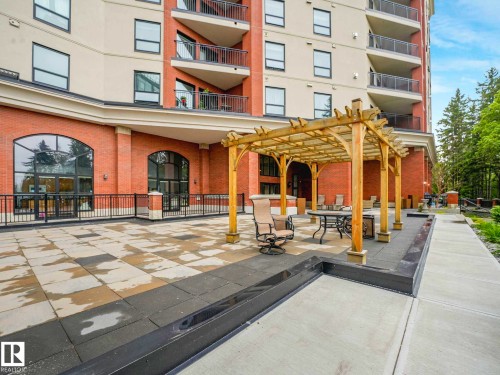 Expansive paver patio featuring a wooden pergola and a raised planting bed - 902 10108 125 Street, Edmonton, AB 
