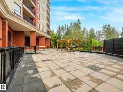 Expansive outdoor patio area featuring a multi-toned paver surface - 