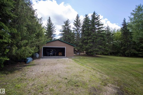 Detached two-car garage with brown siding and a dark green roof - 104 60201 Rng Rd 122, Rural St. Paul County, AB 