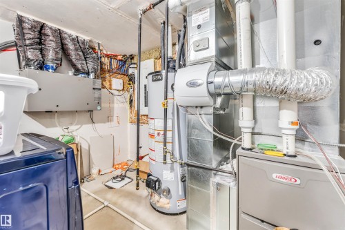 Utility area featuring a Lennox furnace, a water heater, an Aprilaire humidifier, and an air exchanger - 449 Roberts Cres, Leduc, AB 