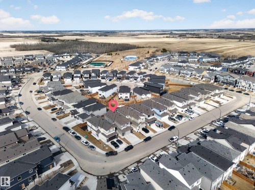 Aerial perspective showcasing a residential community with a mix of detached and semi-detached homes - 449 Roberts Cres, Leduc, AB 