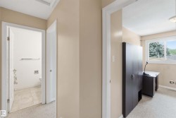 Carpeted hallway with light beige wall paint - 